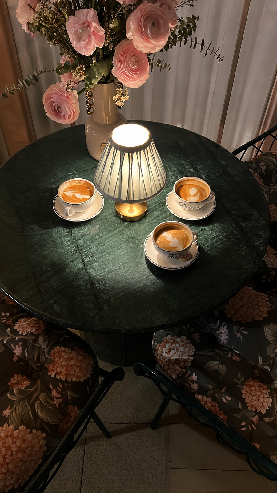 Specialty coffee served around a softly lit table at Hand & Stone
